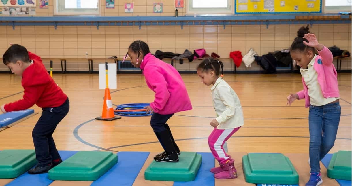 PE slider Kids playing in gym class at school