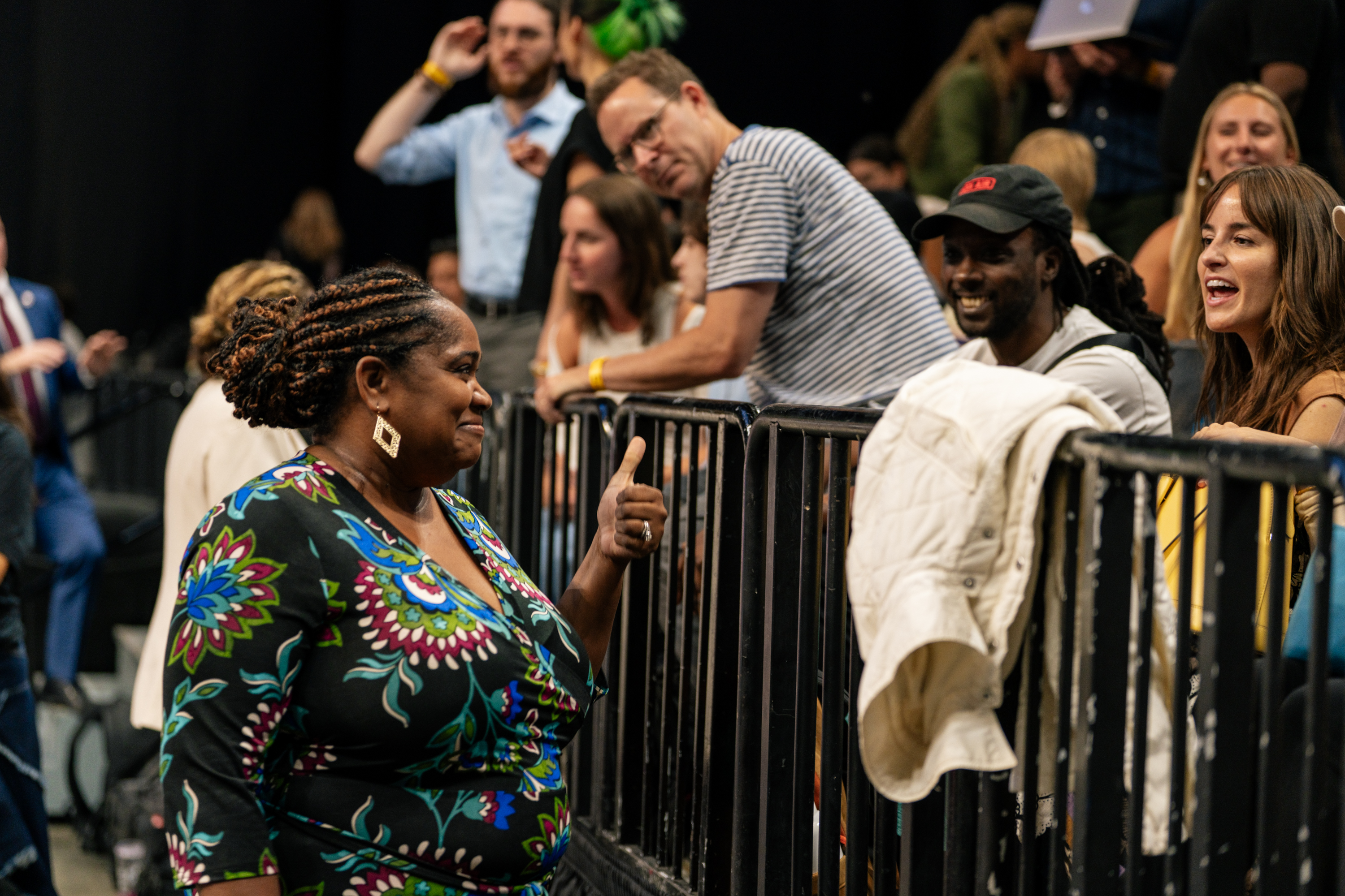 Woman giving thumbs up to crowd Woman giving thumbs up to crowd